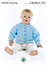 Load image into Gallery viewer, UKHKA 256 Double Knitting Pattern – Baby Cardigan &amp; Cot Blanket